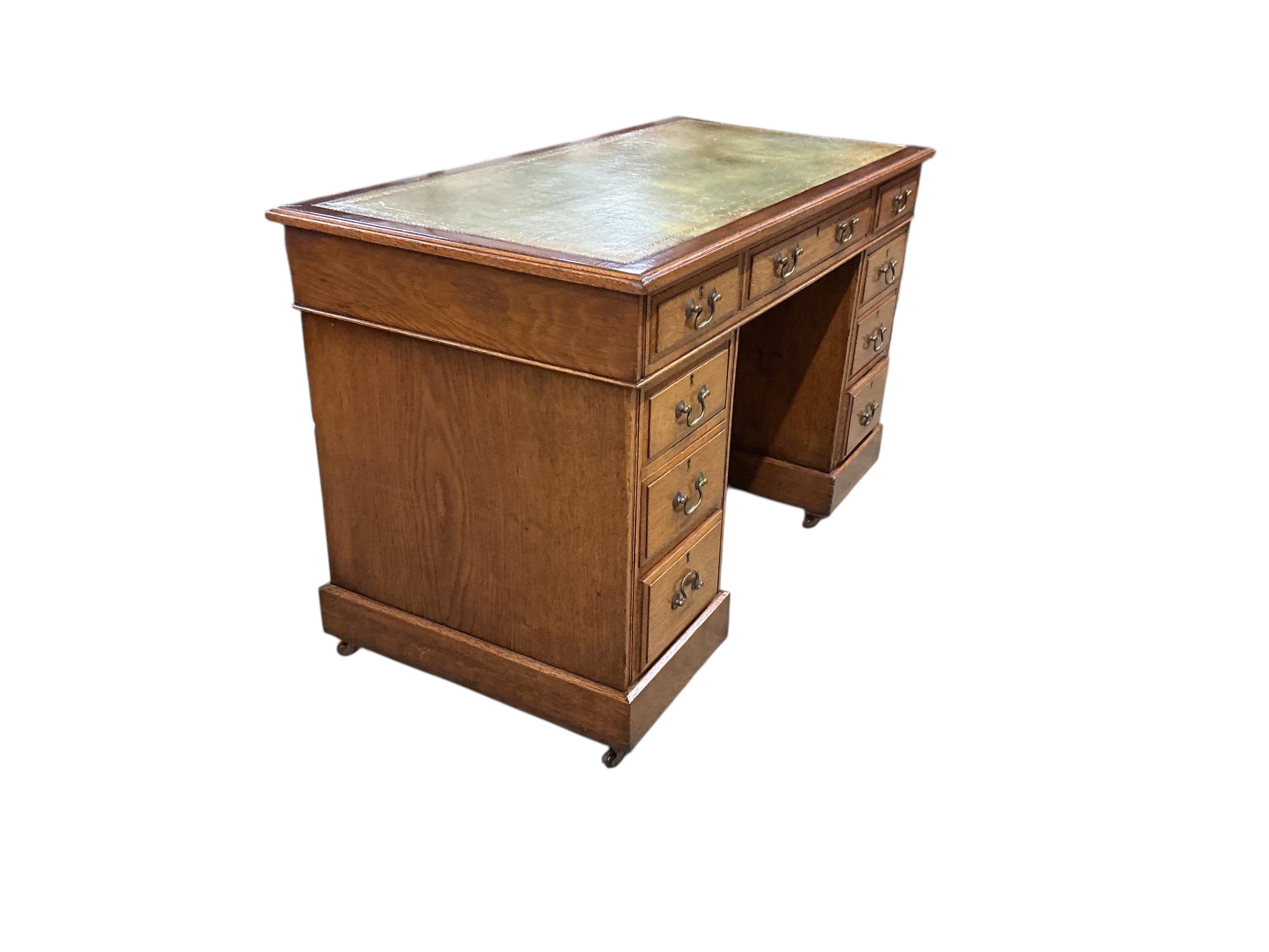 An early 20th century oak pedestal desk, width 122cm, depth 60cm, height 75cm